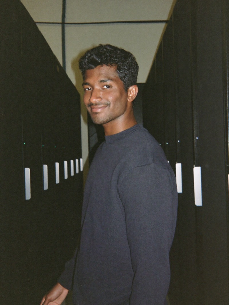 Data center technician in an aisle of server racks